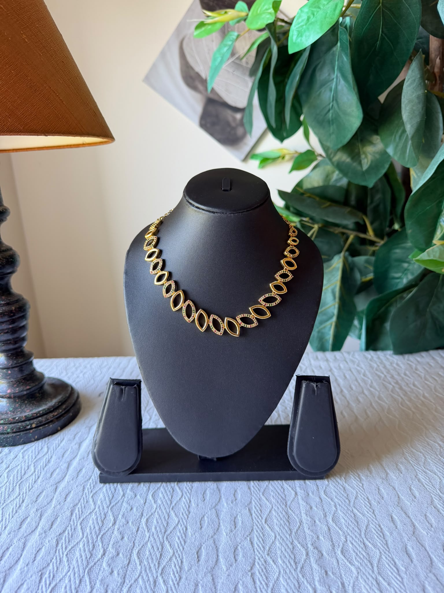 Fancy ruby multicoloured necklace on display stand